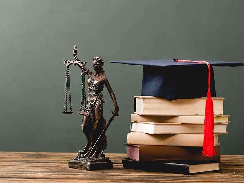 stack-of-books-themis-statuette-and-academic-cap-o-W6NYUBA.jpg